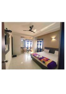 a bedroom with a bed and a ceiling at Hotel UK Palace Puri Near Sea Beach Best Seller in Puri