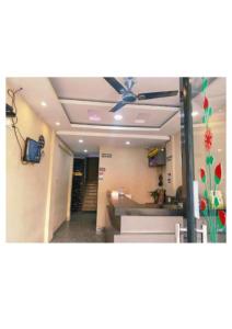 a living room with a ceiling fan in a room at Hotel UK Palace Puri Near Sea Beach Best Seller in Puri