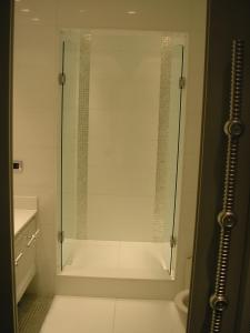 a shower with a glass door in a bathroom at Kiralık Daire - Ritz Carlton Residance Süzer Plaza'da Eşyalı Manzaralı in Istanbul