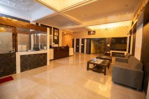 a living room with a couch and a table at HOTEL METRO REGENCY INN in Jaipur