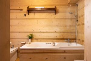 a bathroom with a tub and a sink at Sweet Home Sweet APARTZAKOP in Kościelisko