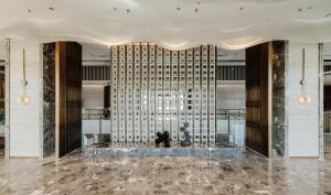 a lobby with a large wall of glass at Radisson Hotel, Beijing DaXing Airport in Beijing