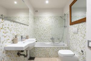 a bathroom with a sink and a toilet and a tub at Ca' Rosa Charming Suite Venice in Venice
