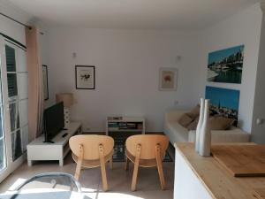a living room with two chairs and a couch at Old Village Vilamoura in Quarteira