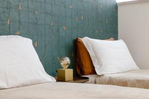 a bedroom with two beds and a trophy on a table at Ca' Rosa Charming Suite Venice in Venice