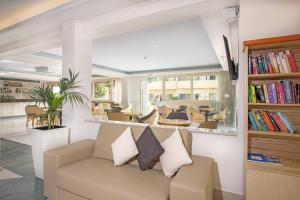 a living room with a couch and a table at Achilleas Beach Hotel in Mastihari