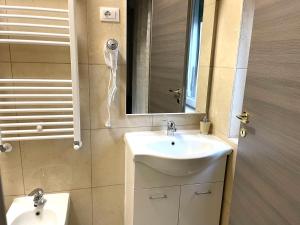 a bathroom with a sink and a mirror at FIERA ROOMS in Verona