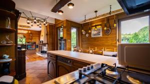 a kitchen with wood paneling and a stove top oven at Grenko House in Vrata