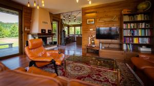 a living room with a couch and a tv at Grenko House in Vrata