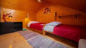 a bedroom with two beds and a flat screen tv at Grenko House in Vrata