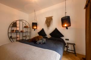 a bedroom with a bed with black pillows and lights at Apt 4 * vue cathédrale Pey Berland in Bordeaux