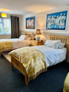 a bedroom with two beds and a lamp at The Traveller's B&B in Louth