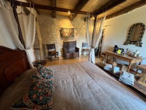 a bedroom with a large bed in a room at Le Relais des Chevaliers " Chambre des Chevaliers" in Cordes-sur-Ciel