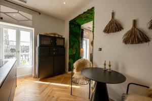 a living room with a table and a tv at Apt 4 * vue cathédrale Pey Berland in Bordeaux