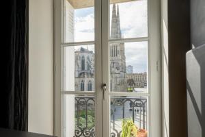 a window with a view of the eiffel tower at Apt 4 * vue cathédrale Pey Berland in Bordeaux