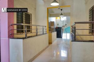 a hallway of a building with a sign that readsmanaged by ox at Townhouse Imperial Inn Hinjewadi in Hinjewadi