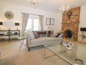 a living room with a couch and a fireplace at The Coach House in Haywards Heath