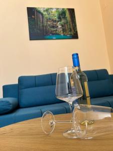 a bottle of wine and a wine glass on a table at Sofias Home in Chania Town