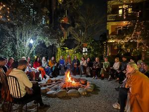 a group of people sitting around a fire at Cloud 9 Garden in Kathmandu