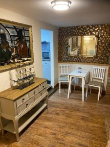 a living room with a dresser and a table with a mirror at The Lair in Whitby