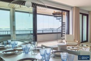a dining room with a table and chairs and a balcony at Premium Duplex Suite I and II floor C09 and C20 in Hanko