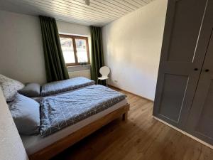 a bedroom with a bed and a window at Urlaub im Sonnendorf Burgberg in Burgberg