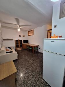 a living room with a white refrigerator and a table at Da Venere in Vasto
