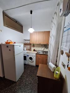 a kitchen with a white refrigerator and a dishwasher at Da Venere in Vasto
