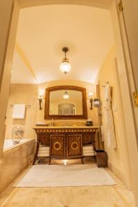 a bathroom with a sink and a mirror at The Leela Palace Bengaluru in Bangalore