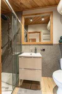 a bathroom with a white sink and a shower at Kosodrzewina in Zakopane