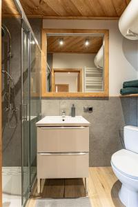 a bathroom with a white sink and a shower at Kosodrzewina in Zakopane