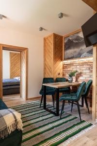 a room with a table and chairs and a bedroom at Kosodrzewina in Zakopane