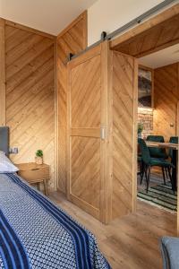 a bedroom with a wooden sliding barn door at Kosodrzewina in Zakopane