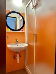 a bathroom with a sink and a mirror at Hotel Enna Rimini in Rimini