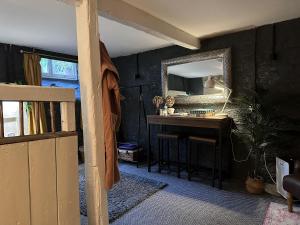 a room with a table and a mirror and a desk at Charming two-bedroom apartment, One Drake Road, Tavistock in Tavistock