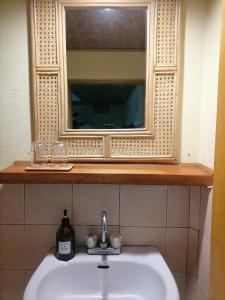 a bathroom sink with a mirror and a sink at VILLA MARMARINE BEACH RESORT & RESTAURANT in Siquijor