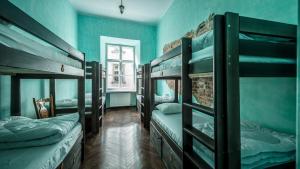 a room with four bunk beds and a window at The Little Havana Party Hostel in Kraków
