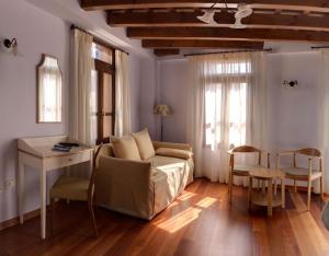 a living room with a couch and a table at Palazzo Duca in Chania