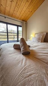 a large bed in a bedroom with a large window at Le Bon'abry #Balnéo#Terrasse#Garage in Orcines