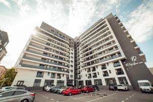 a large building with cars parked in a parking lot at Luxury Collection Studios at Q Residence Palas Mall in Iaşi