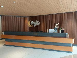 a lobby with a counter in a building at Skysuites Residence in Kedungbaruk