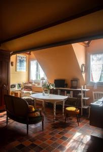 a living room with a table and chairs at La Noisetiere in Noyers-sur-Cher