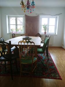 a dining room with a table and chairs at Weltenhaus in Unterumbach