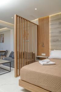 a bedroom with a bed and a living room at Anele Luxury Suites in Chania Town