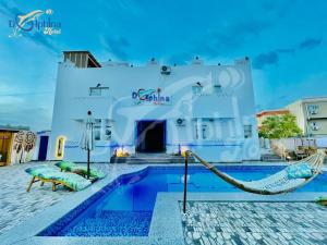 a swimming pool in front of a building at Dolphina hotel & Restaurant in Dahab