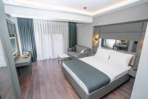 a hotel room with a bed and a couch at 216 Style Suite in Istanbul