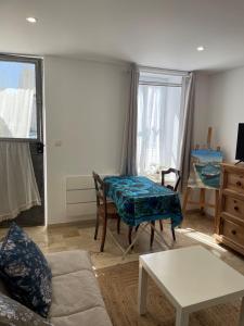 a living room with a couch and a table at L Atelier, studio au petit port de Martigues in Martigues