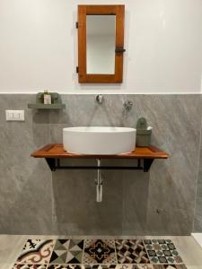 a bathroom with a sink and a mirror on a wall at Le finestre sul mare in Rio Marina