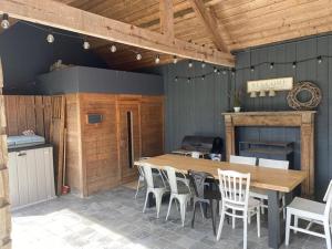 a dining room with a wooden table and chairs at Les Hirondelles de Durbuy in Durbuy