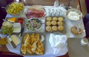 a table with a bunch of different types of food at Petesville Hotel Limited in Calabar